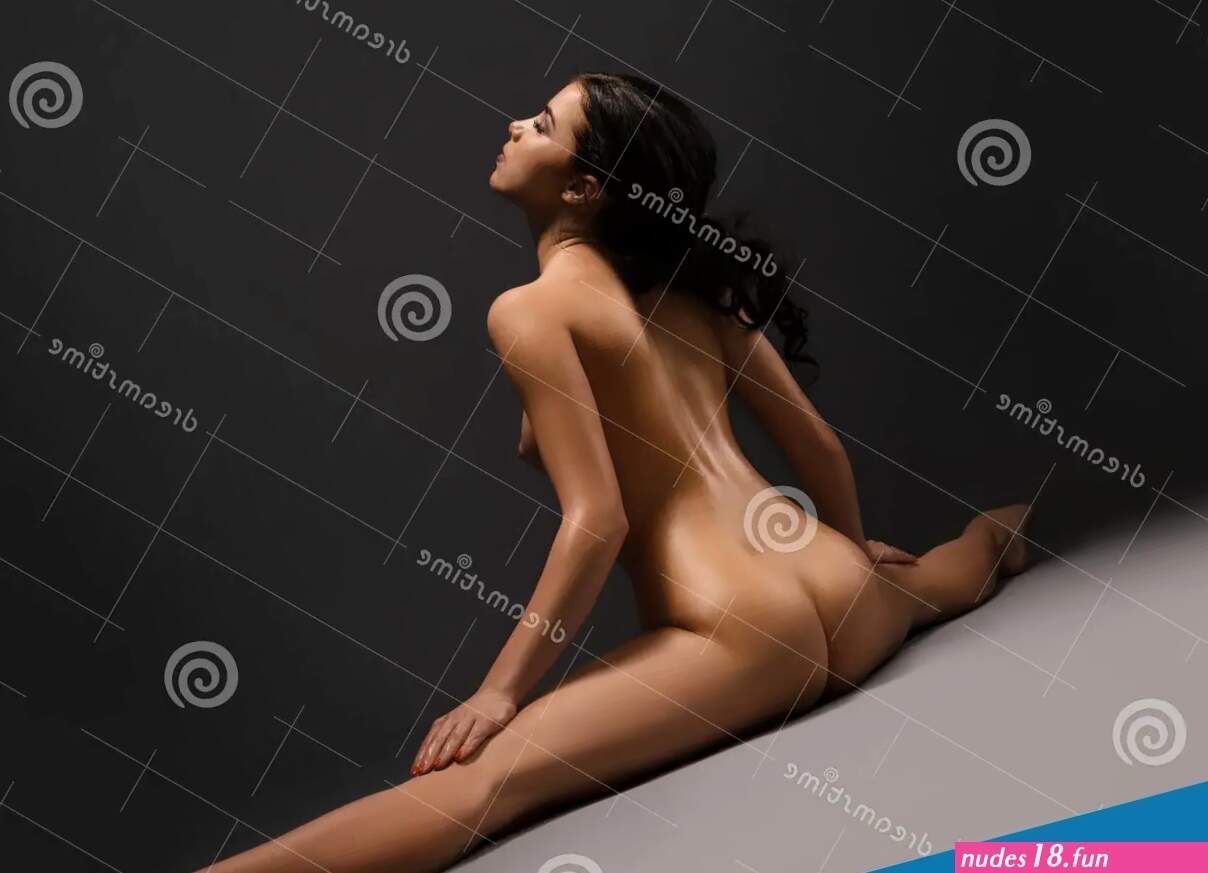Beautiful Naked Woman Doing Splits at Dark Studio Stock Photo