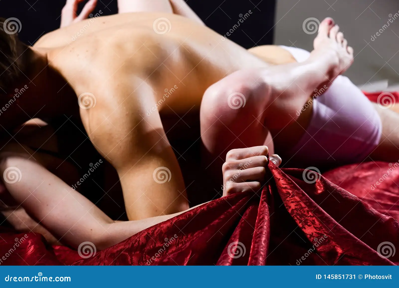 Hand Squeeze Bedclothes. Naked Lovers Passionate Sex. Woman Embrace Lover by Legs Stock Image