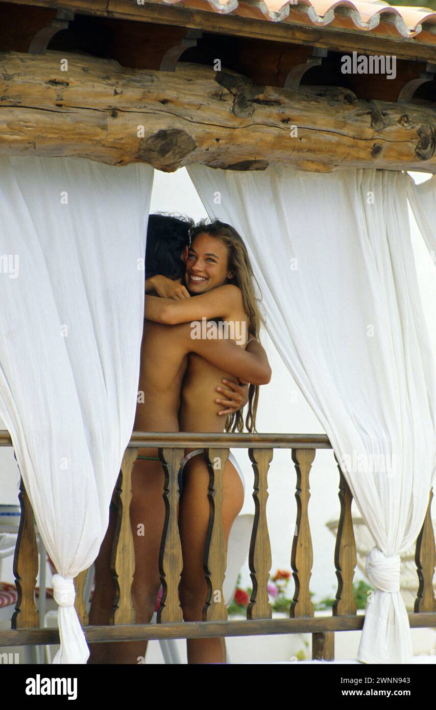pretty young couple nude between white curtains on balcony very romantic close up smiling happiness Stock Photo