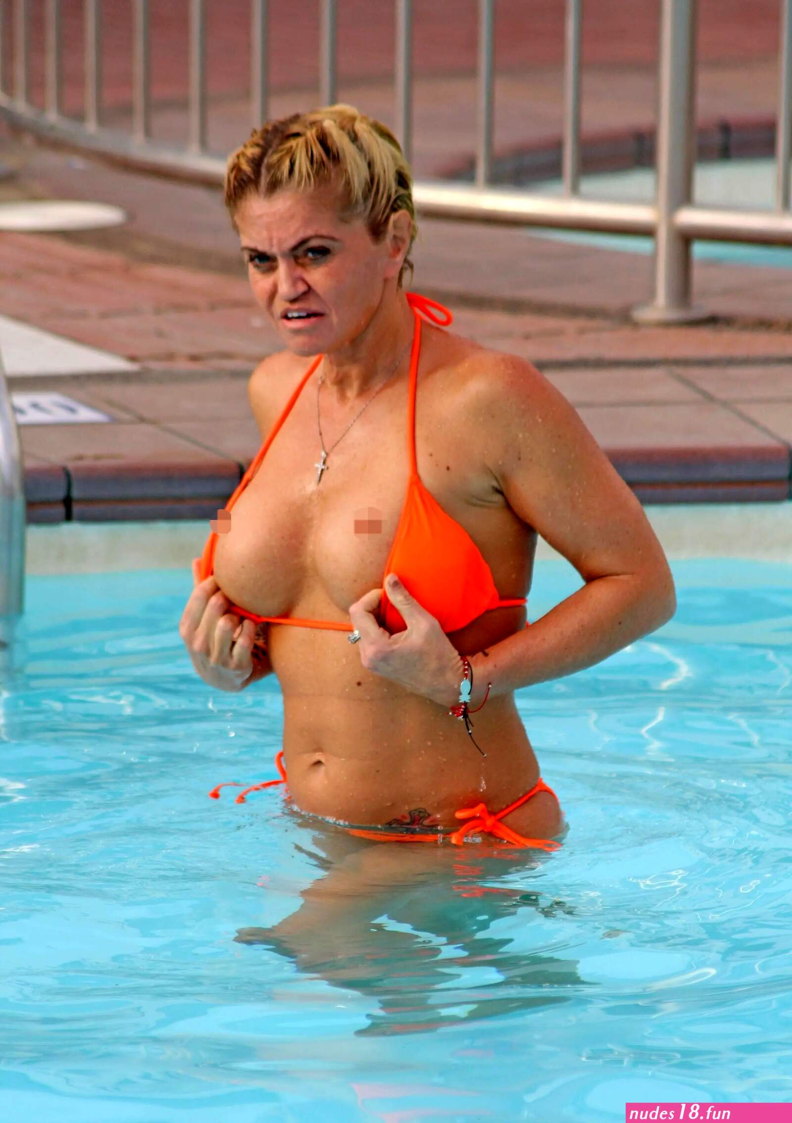 Danniella Westbrook pulls down her bikini top in the pool on holiday in Spain