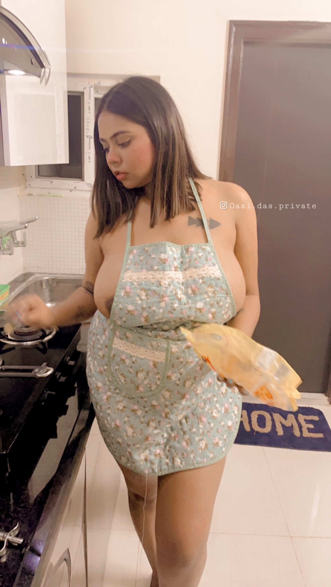 Oasi Das wearing just an apron and showing her glimpses of nude boobs and nipples inside